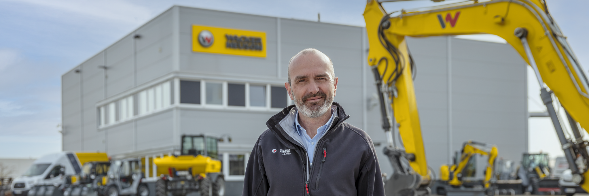 Wacker Neuson employee standing in front of Wacker Neuson rental station.