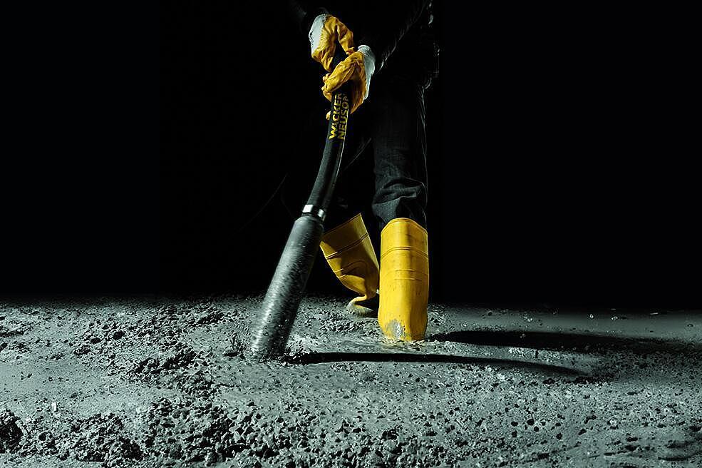 concrete consolidation with an internal vibrator in action