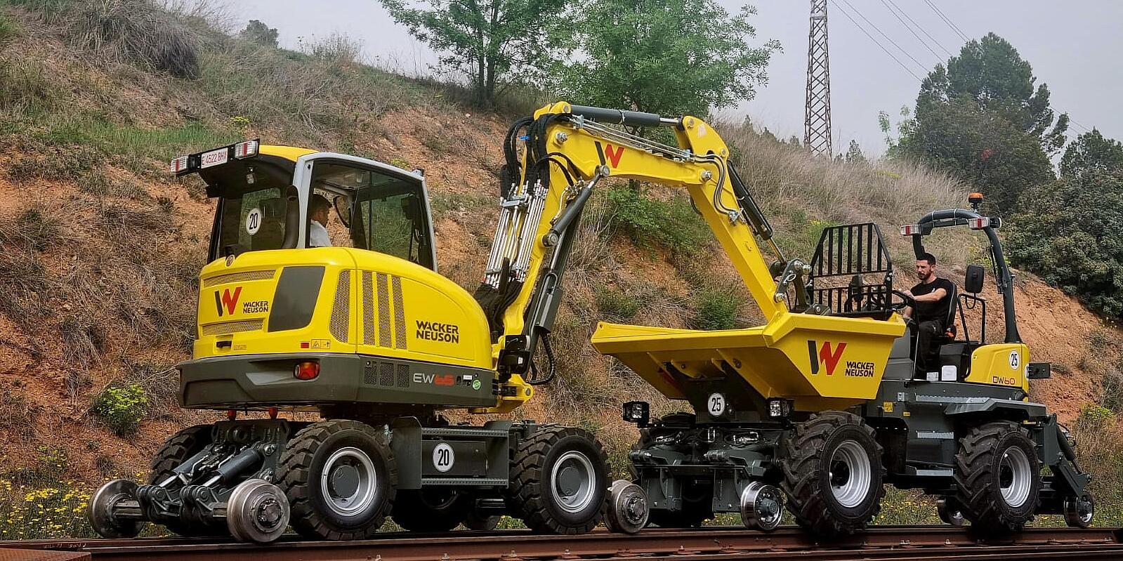 railrway excavator and railway dumper together in action on track