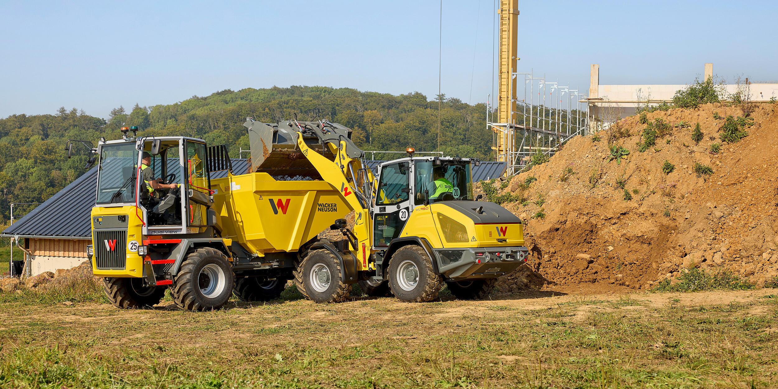 Wacker Neuson WL950 wheel loader loading excavated soil into a Wacker Neuson dual view dumper on a construction site.
