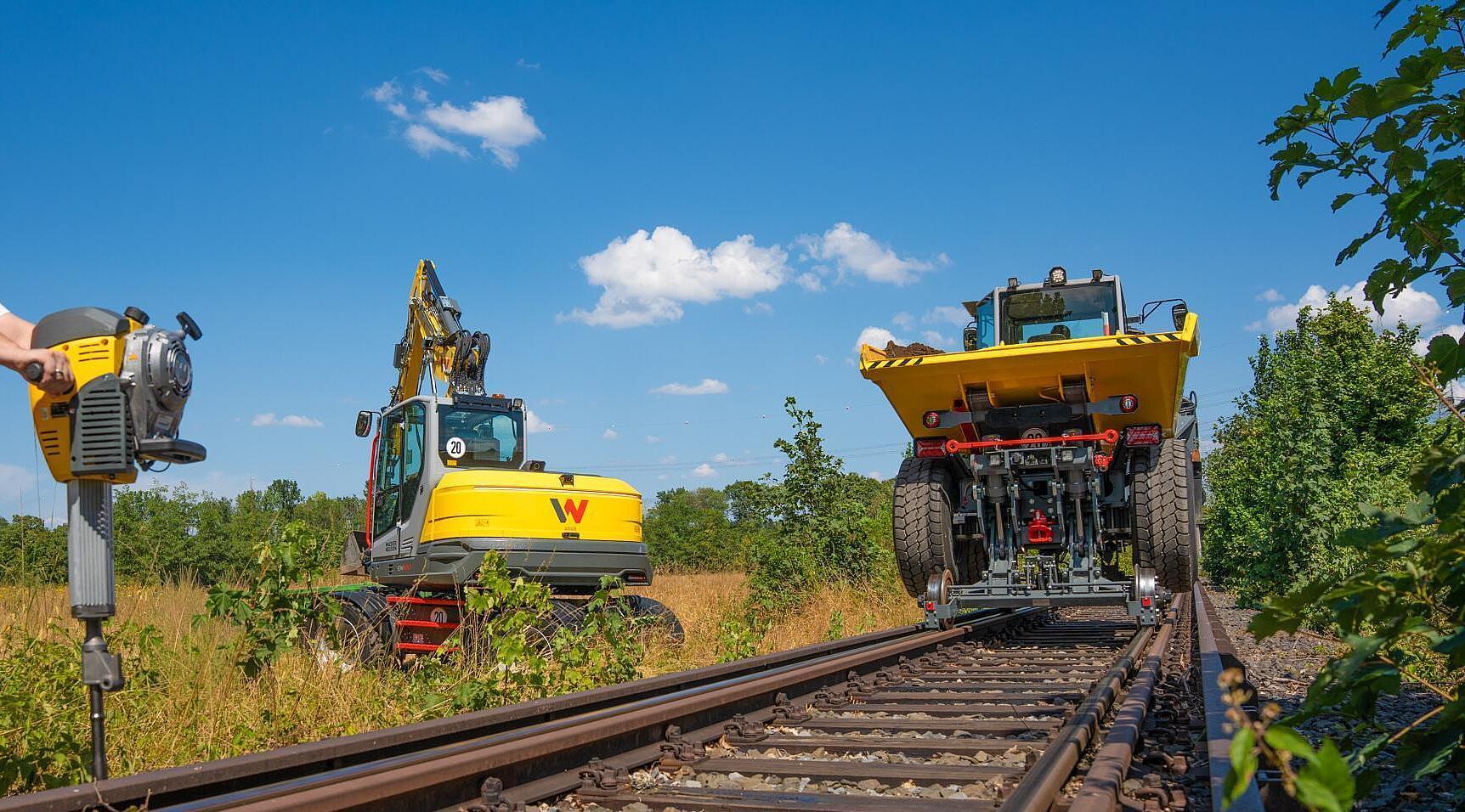 Railroad dumper, excavator and gasoline breaker at work