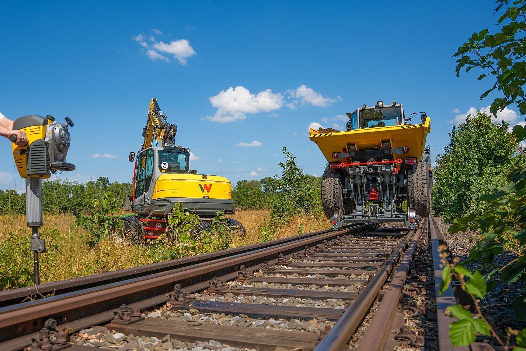 Railroad dumper, excavator and gasoline breaker at work