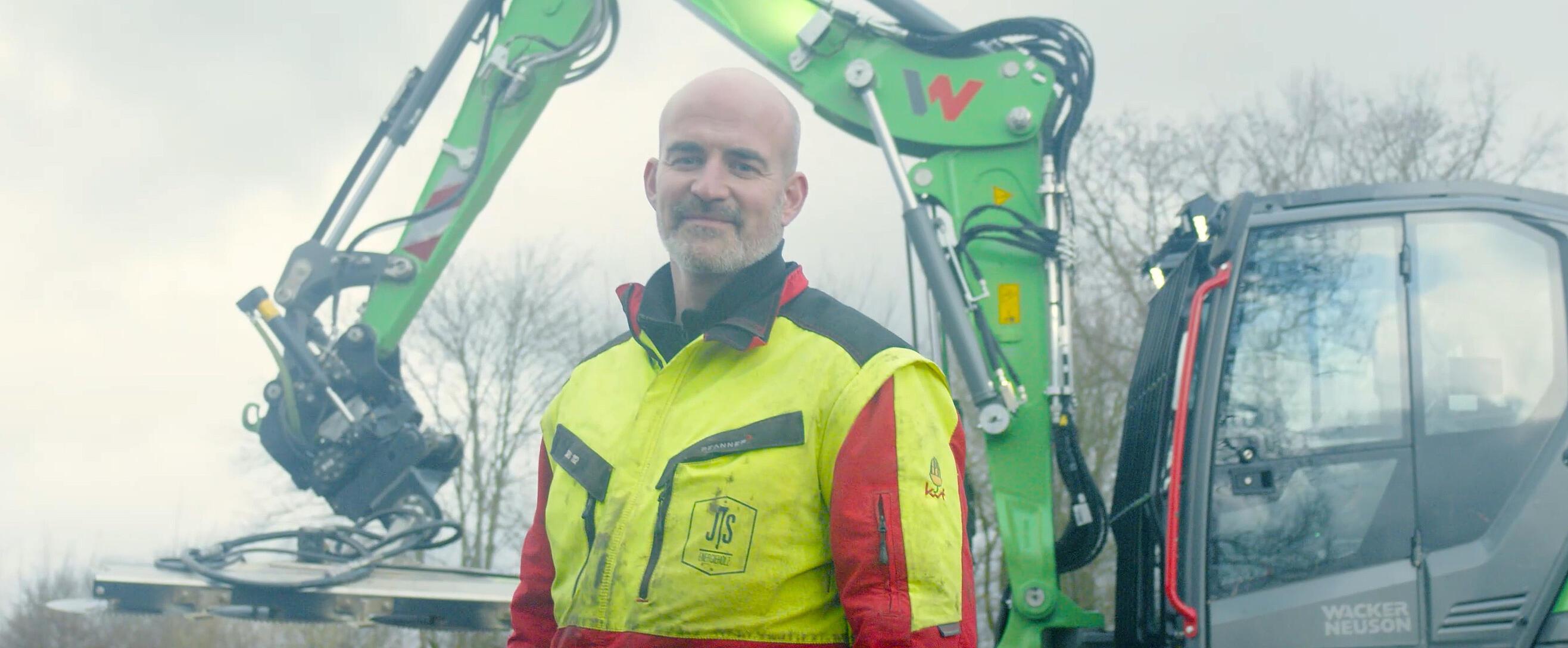 man standing infront of excavator