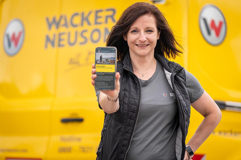 woman holding a smartphone in the camera